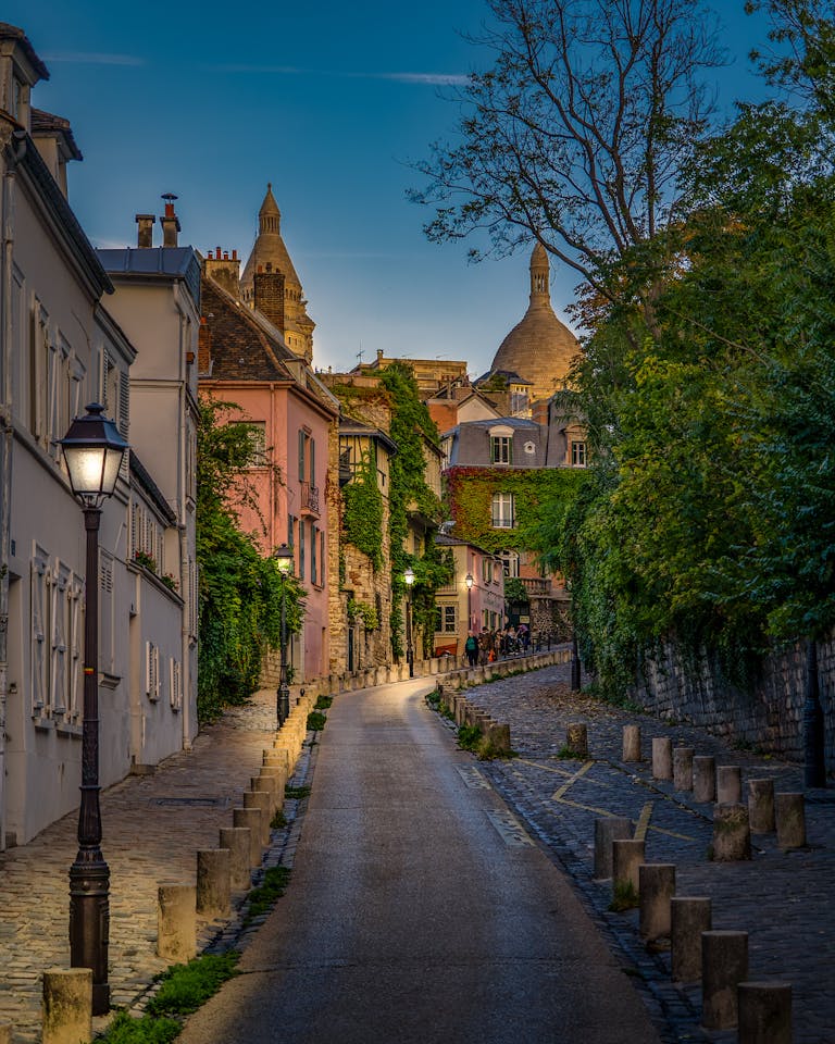 Explore a picturesque evening street in Montmartre, Paris, surrounded by historic architecture.