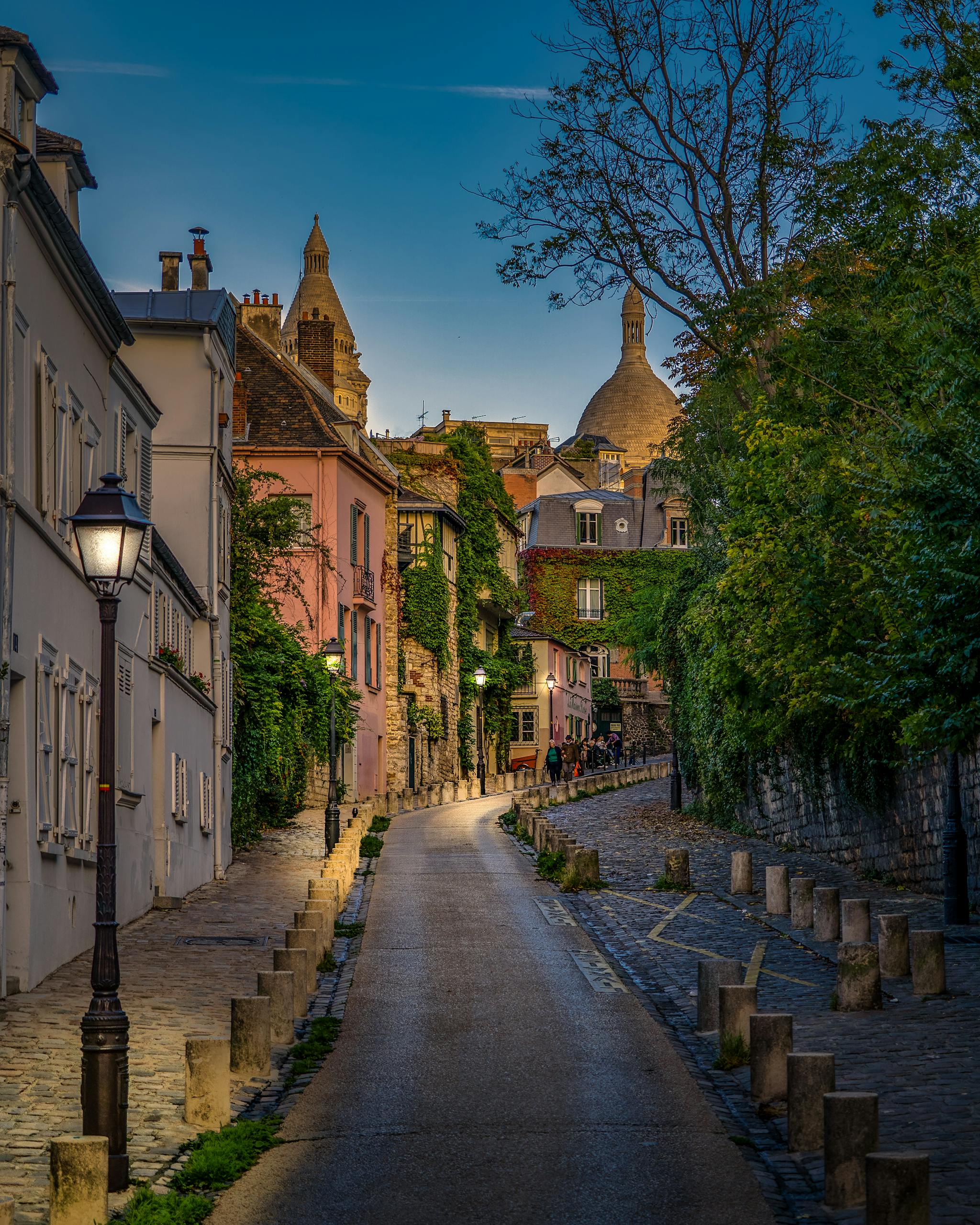 Explore a picturesque evening street in Montmartre, Paris, surrounded by historic architecture.